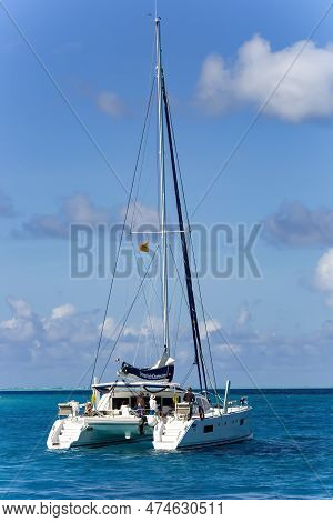 French Polynesia, Papeete, December, 2017 -  Lonely Catamaran With Tourists In A Beautiful Turquoise