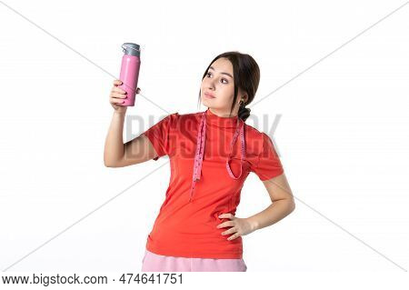 Front View Of A Concentrated Young Girl In Redorange Blouse Holding Metre And Thermos On White Backg