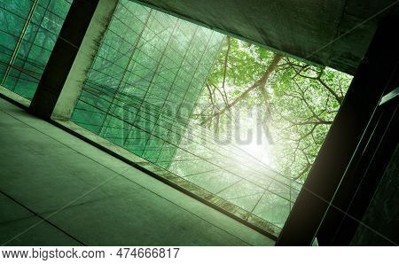Sustainble Green Building. Eco-friendly Building In Modern City. Sustainable Glass Office Building W
