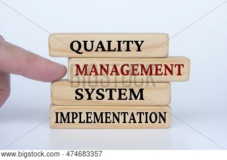 Quality Management System Implementation Text On Wooden Blocks. Business Culture And Operational Exc