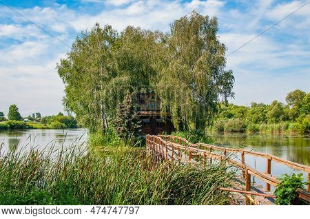 Wooden House On The Island In The Middle Of The Lake