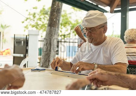 Miami, Florida - May 02, 2015: Little Havana District In Miami And People Playing Domino In Maximo G