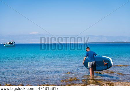 Man Riding Sup Stand Up Paddle On Vacation.