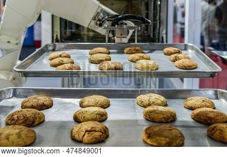 Robot Arm Preparing Cookies For The Oven In Production Line Factory, Industrial Food Production
