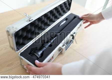 Woman Opens Silver Case With Modern Laowa Lens For Camera On Wooden Table. Purchase Of Professional 