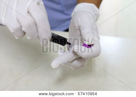 Nurse Taking Blood Sample From Patient At The Doctors Office