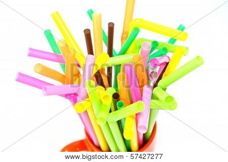 group of colourful straws in a mug