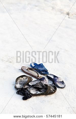 Frozen Slippers Near Edge Of Ice Hole