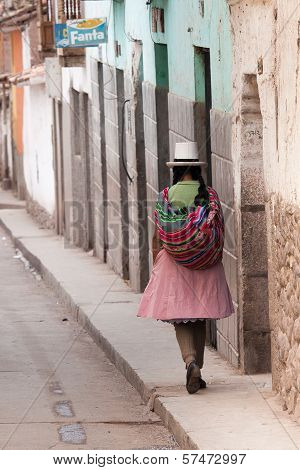 Quechua Woman Walking The Streets Of Calla, Peru