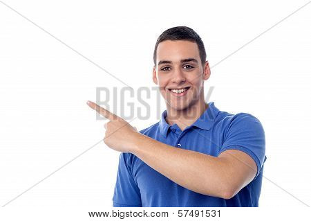 Cheerful Teenager Pointing Away