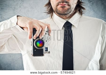 Businessman Taking Photo With Retro Style Camera