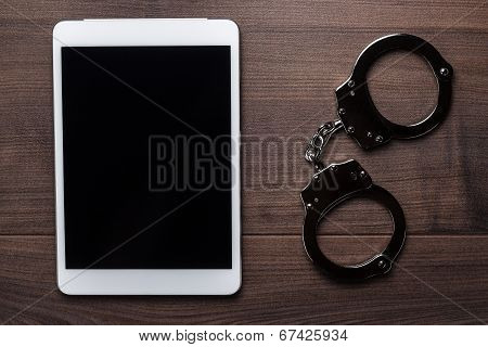 handcuffs and tablet computer