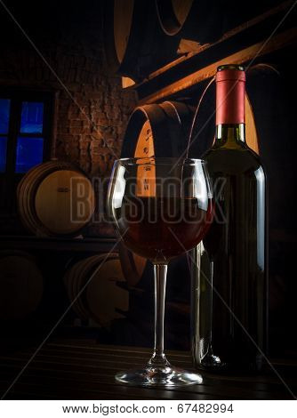 Wine Glass Near Bottle In Old Wine Cellar