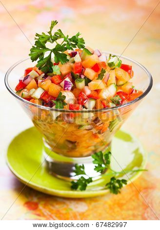 Fresh melon salsa with red pepper and cucumber