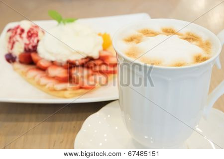 Cappuccino Coffee Cup And Vanilla  Ice Cream With Strawberry And Whipp Cream In Background