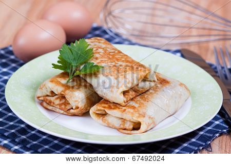 Pancakes with stuffed on a plate
