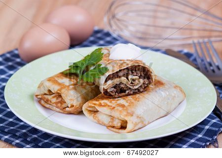 Pancakes with stuffed on a plate