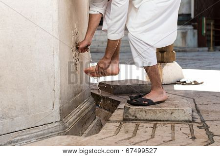 Muslim Washing Feet Before Entering Mosque