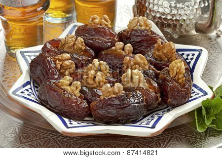  Dish with preserved ripe Medjool dates stuffed with walnuts for festive occasions
