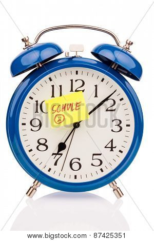 an alarm clock with a sticky note school as a symbol photo for starting school