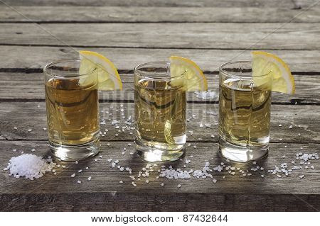 Three Glasses Of Tequila With Lemon And Salt