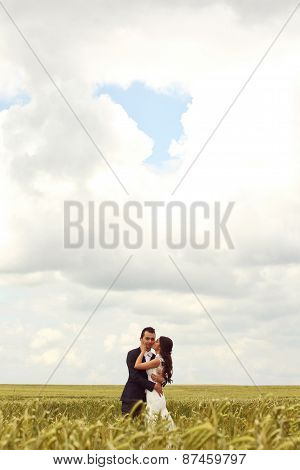 Bride And Groom Posing In The Fields