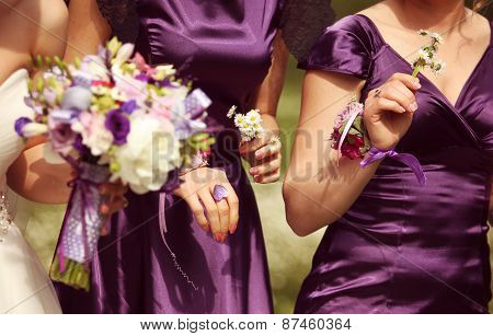Bride holding flower bouquet with bride's maids