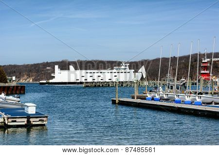 PORT JEFFERSON, NY - April 6, 2015: Auto Ferry leaving port. The ferry 'Park City' leaves Port Jefferson, New York for Bridgeport Connecticut. The boat can carry 95 vehicles and 1,000 passengers.