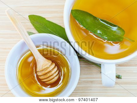 A Cup Of Sage Tea With Fresh Sage And Honey.