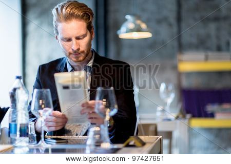 Businessman Holding The Menu In A Restaurant
