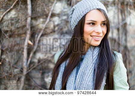 Portrait Of A Smiling  Young Woman In Autumn Ambient