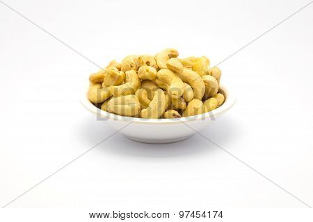 A cup of cashew nuts on white background