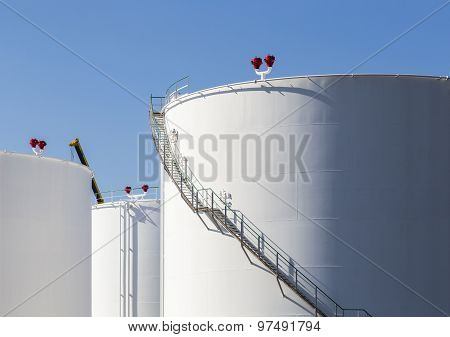 White Tanks In Tank Farm With Iron Staircase
