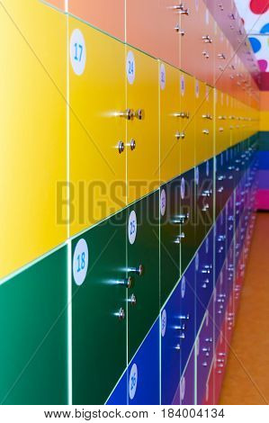 The wall is decorated with multi-colored storage chambers. A variant of the interior for children's rooms shops gambling halls. Numbered cell storage in a baggage room