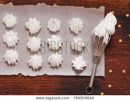 Top view of hite raw meringue made of whipped eggs ready to bake