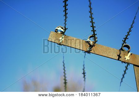 The barbed wire is taut over the prison wall. close up. Preventive measure of safety from escaping prisoners.