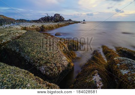 Long exposure of sea & rocks during beautiful evening at Labuan island,Malaysia.Known as Bonsai lonely tree Layang Layangan & lconic landmark in Labuan island,Malaysia.