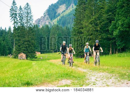 family of four cycling by the vilsalpsee in austria