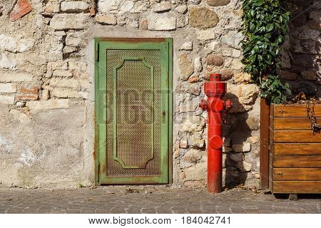Old red fire hydrant in the street. Fire hidrant for emergency fire access .
