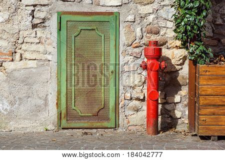 Old red fire hydrant in the street. Fire hidrant for emergency fire access .