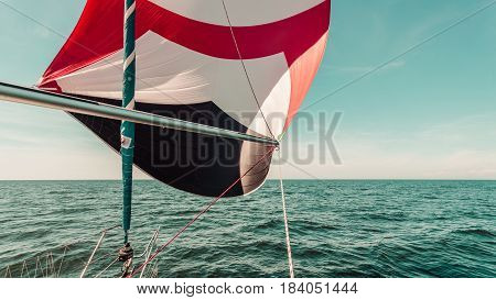 Spinnaker With Uphaul, Blue Sky In Background.