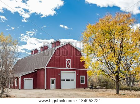 An old red barn in an autumn landscape