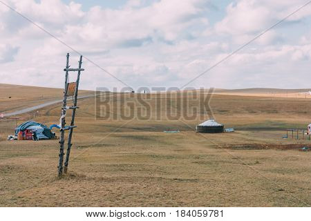 Group Of Yurts In Mongolia Grassland With Blue Sky,horizontal