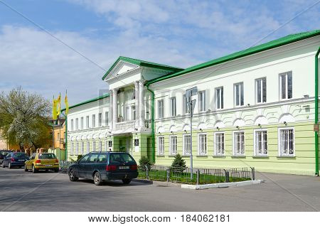 GOMEL BELARUS - APRIL 27 2017: Unknown man walk along street near building of Gomel Regional Union of Consumer Societies Gomel Belarus