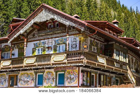 Canazei Italy - April 26 2012: Traditional fully decorated houses in the old village