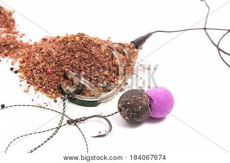 Dry Feed For Carp Fishing. Ready For Use Carp Bait With Fishing Flat Feeder For Carp Fishing Isolate