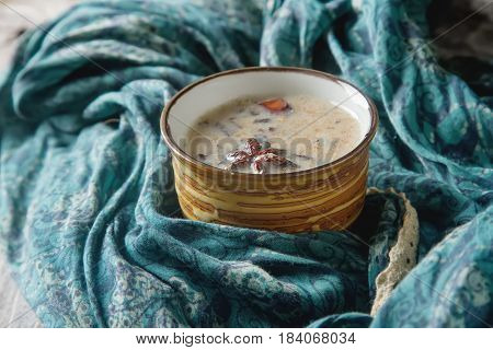 Traditional Indian Masala Tea In Ceramic Cup With Spices To Milk