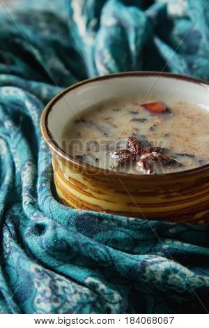 Traditional Indian Masala Tea In Ceramic Cup With Spices To Milk