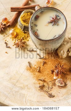 Traditional Indian Masala Tea In Ceramic Cup With Spices To Milk