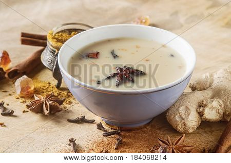 Traditional Indian Masala Tea In Ceramic Cup With Spices To Milk